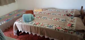 a bedroom with two twin beds with a table at Pousada Pé do Morro in Vale do Capao