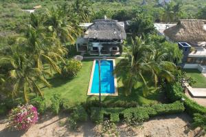 an aerial view of a villa with a swimming pool at Casa Maya private villa on the beach in Puerto Escondido