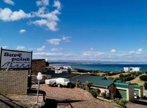 a sign on a building with the ocean in the background at Surf Point 7 in Jeffreys Bay