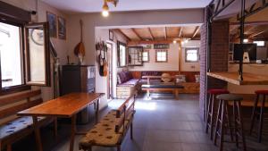 a room with tables and chairs and a living room at Studios Arabas in Thessaloniki