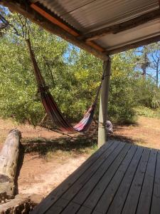 a hammock on a porch of a house at Gran escape! Santa Ana in Cuchilla Alta