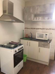 a kitchen with a white stove and a microwave at Gran escape! Santa Ana in Cuchilla Alta