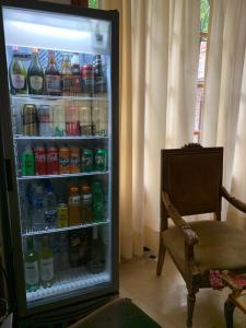 a refrigerator filled with lots of drinks and a chair at SOLES Hostel Boutique in Rosario