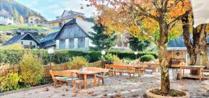 a restaurant with tables and chairs and a tree at Salt&Pepper in Ebene Reichenau