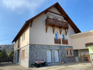 a house with a balcony on top of it at Relax Bogács in Bogács