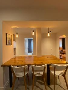 a dining room with a wooden table and chairs at Apartament Mony in Timişoara