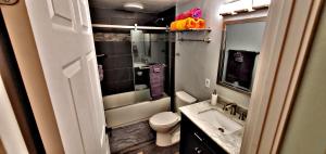 a small bathroom with a toilet and a sink at Ali'i Banyan Breeze in Kailua-Kona
