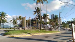 a street with palm trees on the side of the road at Apto acochegante com Praia e lazer in São Vicente