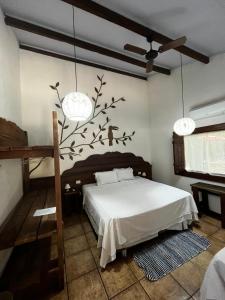 a bedroom with a bed with a tree sticker on the wall at Aymara Lodge in Poconé