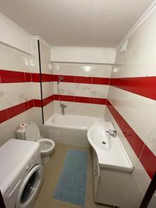 a bathroom with a white sink and a toilet at Home sweet home in Chişinău