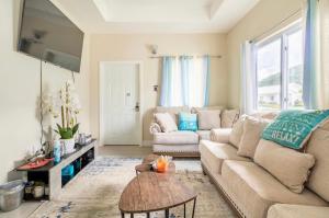 a living room with a couch and a table at Natty’s Cozy Beach house in Hanover Jamaica in Point