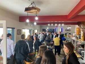 a crowd of people standing in a room at Pousada Leitzke in Piratini