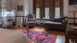 a bedroom with a bed and a living room at William Henry Miller Inn in Ithaca