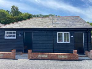 ein kleines blaues Haus mit zwei Fenstern in der Unterkunft The Lydden Bell in Dover