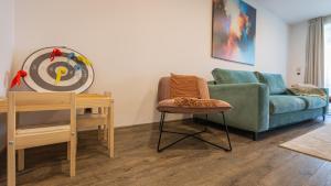 a living room with a couch and a table at Charming family condo in Silver Mountain in Poiana Brasov