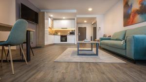 a living room with a couch and a table at Charming family condo in Silver Mountain in Poiana Brasov