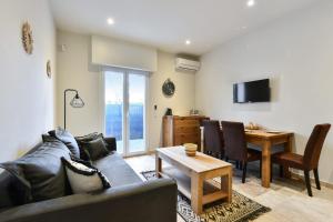uma sala de estar com um sofá e uma mesa em Comfortable flat close to the beach and Marineland Antibes - Welkeys em Antibes