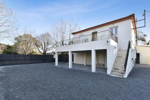 a white house with a staircase in the driveway at Comfortable flat close to the beach and Marineland Antibes - Welkeys in Antibes