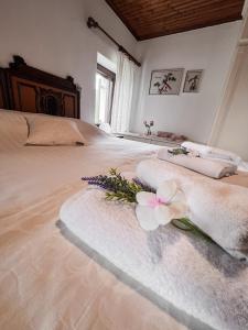 a bedroom with a large bed with a flower on it at The Lady of the Lake in Kalyvia