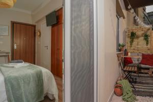 a hallway with a table and a chair in a room at Homey Edessa in Edessa +4 photos