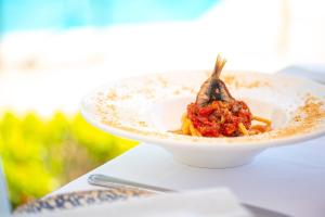 a bowl of food sitting on a table at Hotel Villa Romana in Porto Empedocle