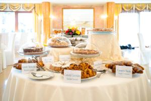 a table with different types of pastries and pies at Hotel Villa Romana in Porto Empedocle