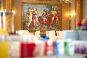 a painting of a group of women on a wall at Hotel Villa Romana in Porto Empedocle