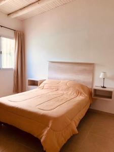 une chambre avec un grand lit dans une pièce dans l'établissement Cabañas Vista Andes VI, à Luján de Cuyo 13 autres photos