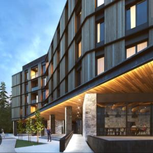 a building with a person standing outside of it at KOPAONIK WOODSIDE 58,70 m2 FREE Parking in Kopaonik