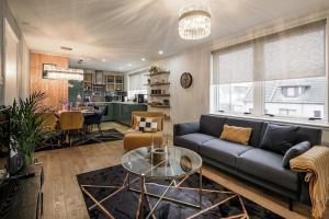 a living room with a couch and a table at Boutique Beachside Apartment with Jacuzzi Bath, Findhorn in Findhorn