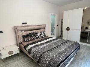 1 dormitorio con 1 cama con almohadas blancas y negras en Aydemir park Mahmutlar 2, en Alanya