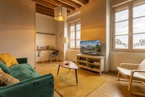 Televízia a/alebo spoločenská miestnosť v ubytovaní L' appartement de la Paix
