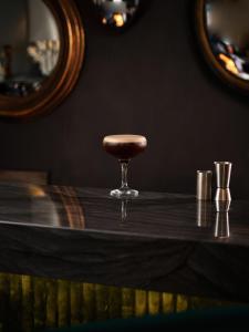 a bar with a stool on a wooden table at Henrietta House, a member of Radisson Individuals in Bath
