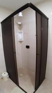 a shower stall in a bathroom with a toilet at Apto acochegante com Praia e lazer in São Vicente +39 photos