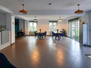 a large room with tables and chairs and windows at HAPPY TIMES in Bran