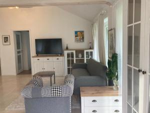 a living room with a couch and a tv at Villa Mato in Piešťany