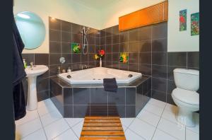 a bathroom with a tub and a toilet and a sink at Amamoor Homestead and Country Cottages in Amamoor +101 photos