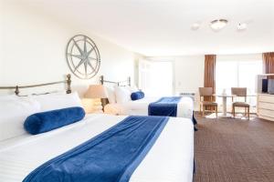 a hotel room with two beds and a television at Dune Crest Hotel in North Truro