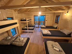 a room with four bunk beds in a cabin at Eko vila Krupa in Krupa na Vrbasu