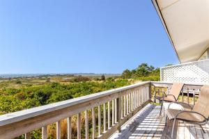 a balcony with chairs and a view of the ocean at Dune Crest Hotel in North Truro