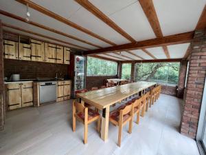 a large kitchen with a wooden table and chairs at Eko vila Krupa in Krupa na Vrbasu
