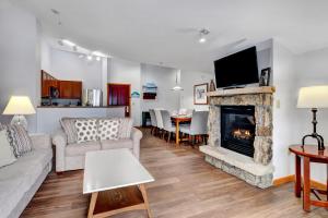a living room with a couch and a fireplace at Ski In Out Luxury Penthouse #1706 With Hot Tub & Great Views - 500 Dollars Of FREE Activities And Equipment Rentals Daily in Winter Park