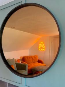 a mirror with a couch in a room at This must be the place - Arran, Lamlash in Lamlash