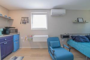a room with a bed and a blue chair in it at TheCozyCorner in Concord in Concord
