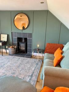 a living room with a couch and a fireplace at This must be the place - Arran, Lamlash in Lamlash