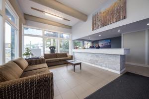 a living room with two couches and a fireplace at The Vista Inn in Kamloops