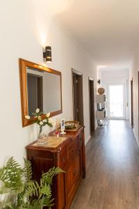 a bathroom with a dresser and a mirror on a wall at Twin House - Amarante in Amarante