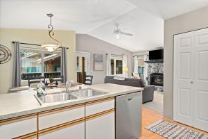 a kitchen with a sink and a living room at Walk to Downtown Festivities 2Bd2Ba Condo in Leavenworth