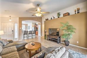 a living room with a couch and a tv at Radiant Peoria Paradise House with Pool and Patio! in Peoria