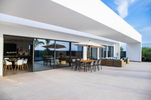 an outdoor patio with tables and chairs and umbrellas at Villa Macán in Teguise